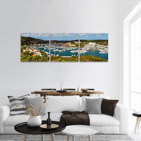 Marina of Porto Cervo Panoramic Canvas Wall Art in white, green and blue, hung on a wall