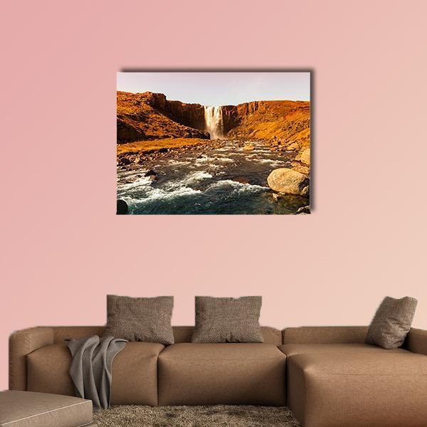 Iceland Waterfall View Canvas Wall Art in brown, orange and blue, single panel hung on a wall