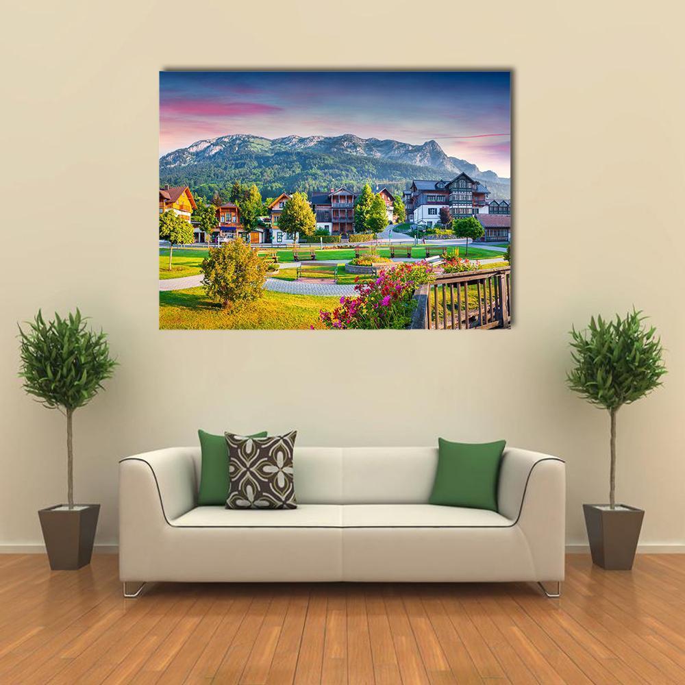 Alpine Village at Sunset Canvas Wall Art in green, blue and pink, single panel hung on a wall