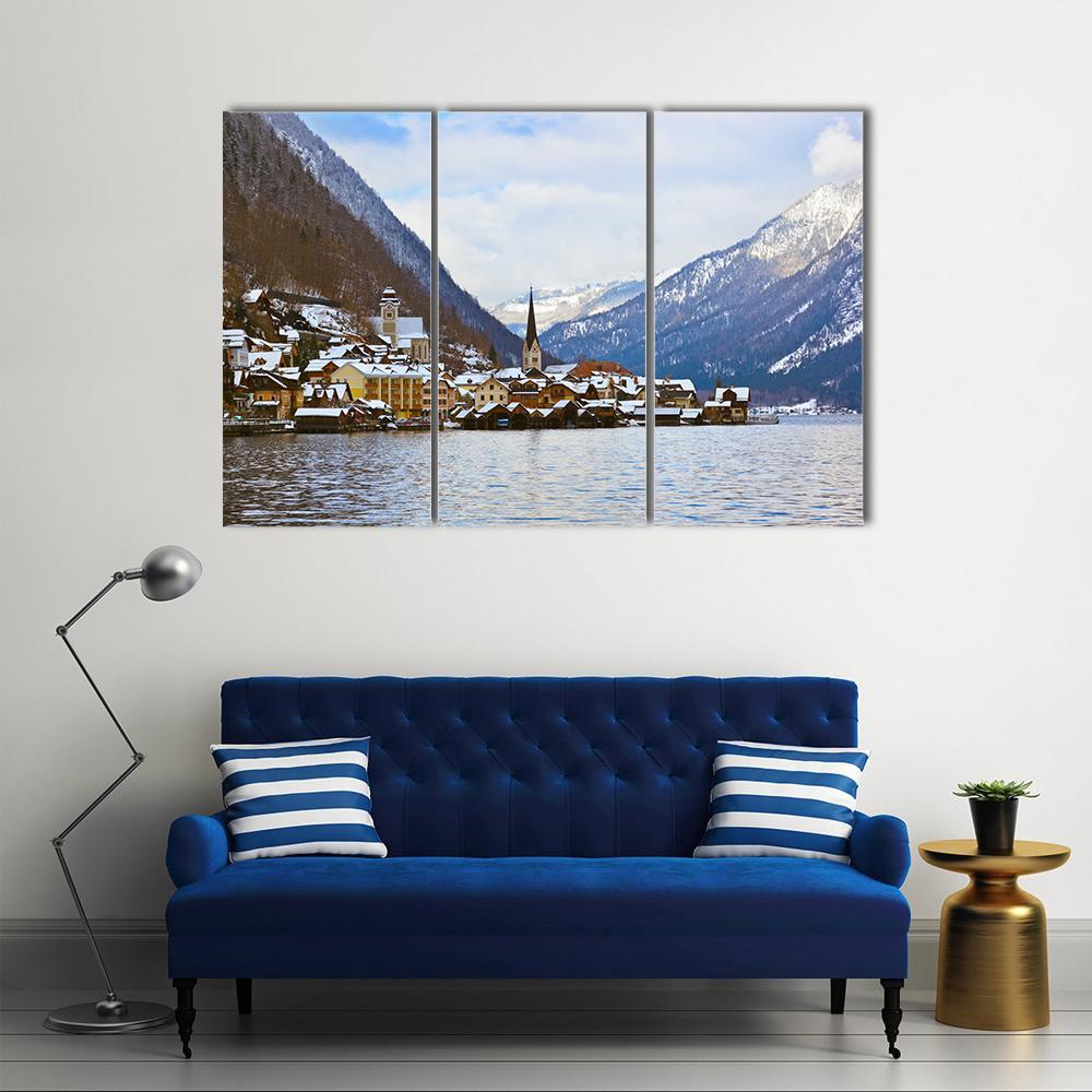 Hallstatt Village on Lake in Winter Canvas Wall Art in white, gray and blue, 3 panel horizontal set hung on a wall