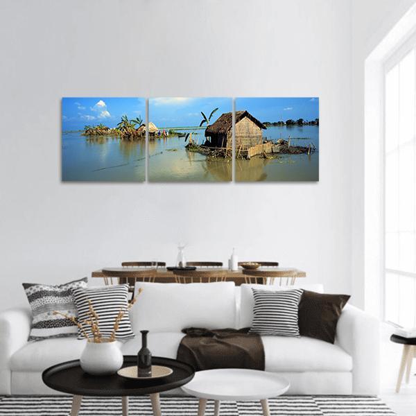 Flooded Village Huts in Bangladesh Panoramic Canvas Wall Art in brown and blue, hung on a wall