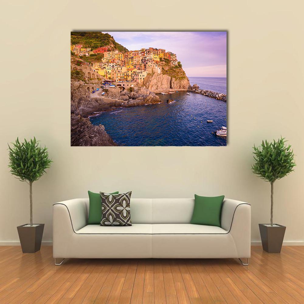 Manarola Cinque Terre Coastal Village at Dusk Canvas Wall Art in orange, blue and purple, single panel hung on a wall