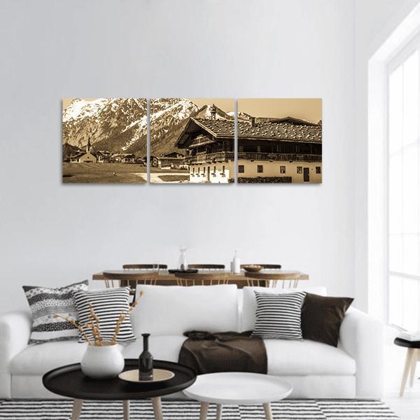 Sepia Alpine Village with Chalet Panoramic Canvas Wall Art in white, beige and brown, hung on a wall