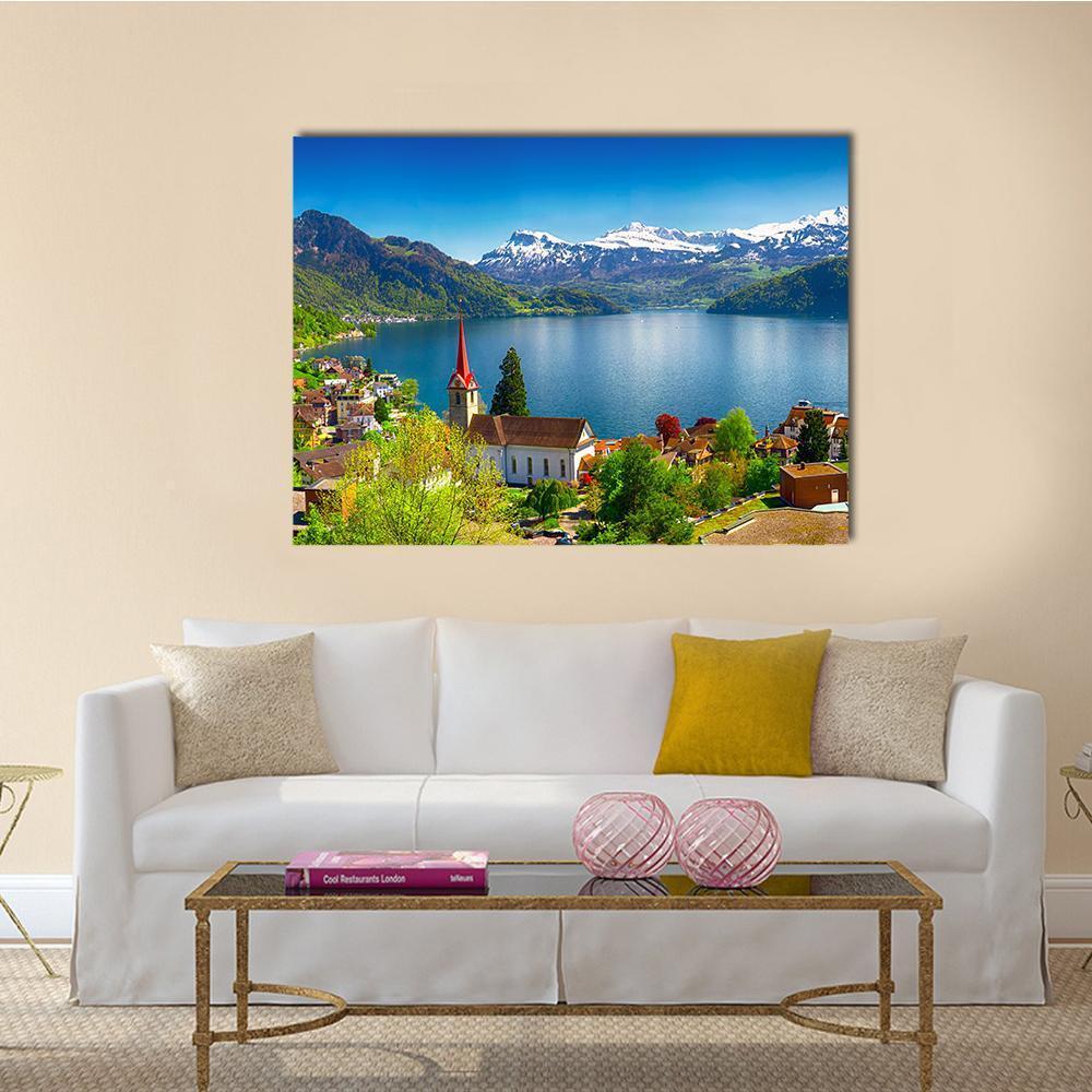 Wegis Village by Lake Lucerne and Pilatus Canvas Wall Art in green and blue, single panel hung on a wall