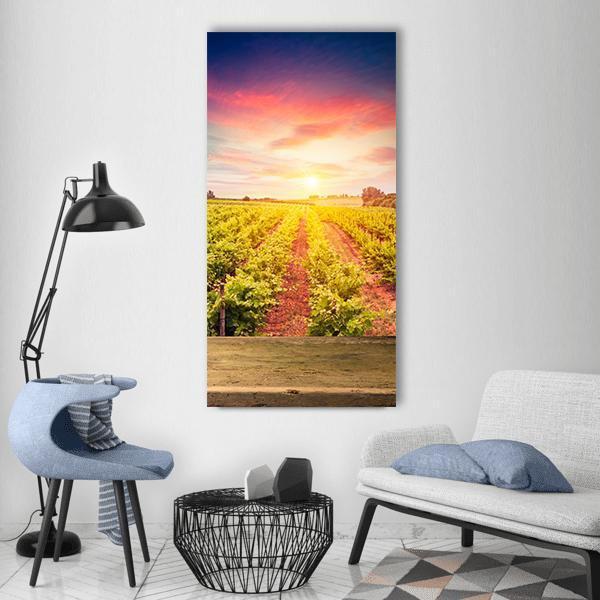 Tuscan Vineyard Sunset Vertical Canvas Wall Art in orange, yellow and pink, single vertical panel hung on a wall