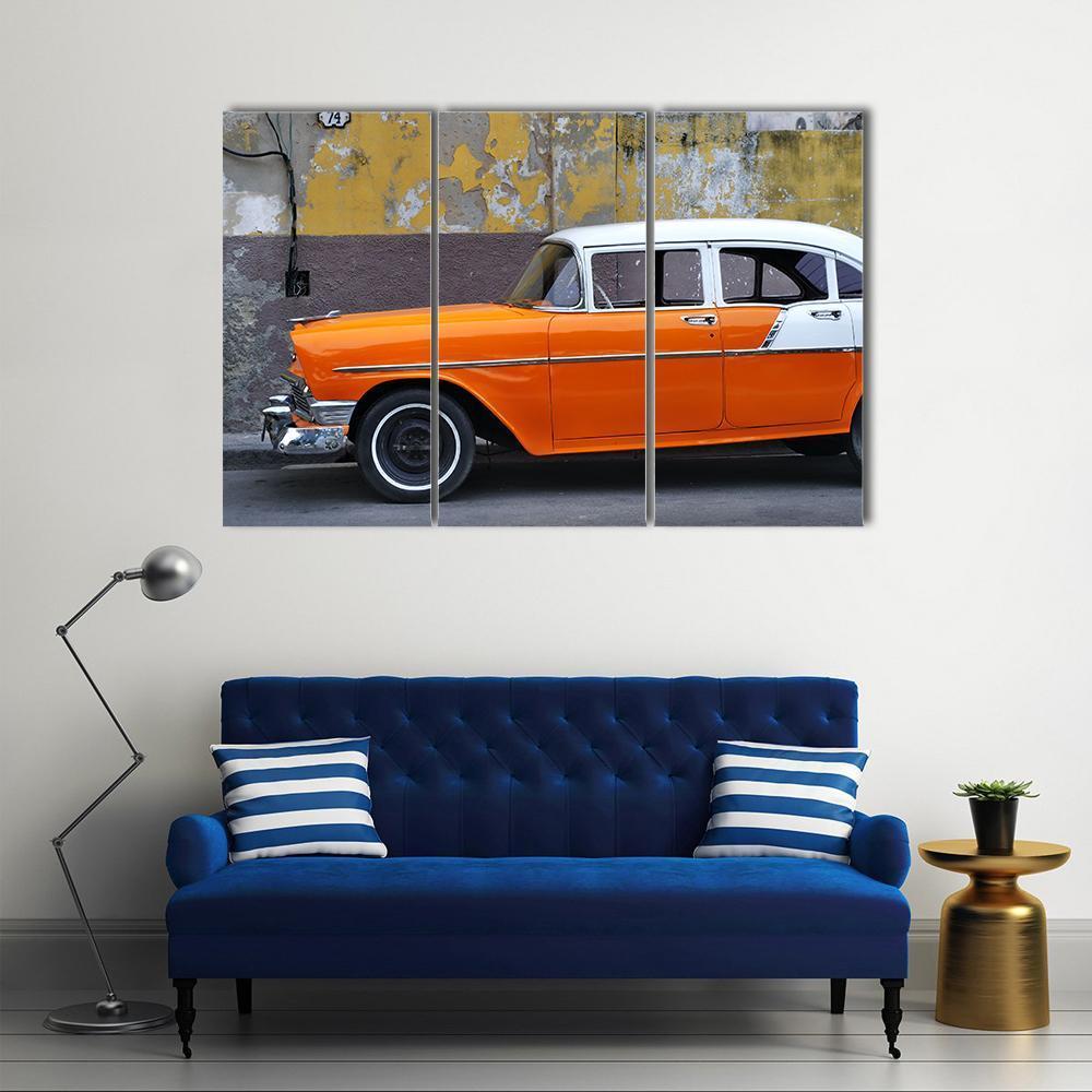 Vintage Orange Car on Havana Streets Canvas Wall Art in gray, orange and yellow, 3 panel horizontal set hung on a wall