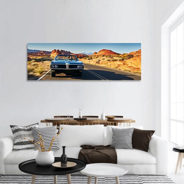 Classic Muscle Car on Desert Road Panoramic Canvas Wall Art in brown, orange and blue, single panel hung on a wall