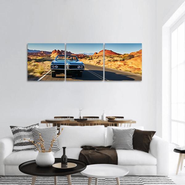 Classic Muscle Car on Desert Road Panoramic Canvas Wall Art in brown, orange and blue, hung on a wall
