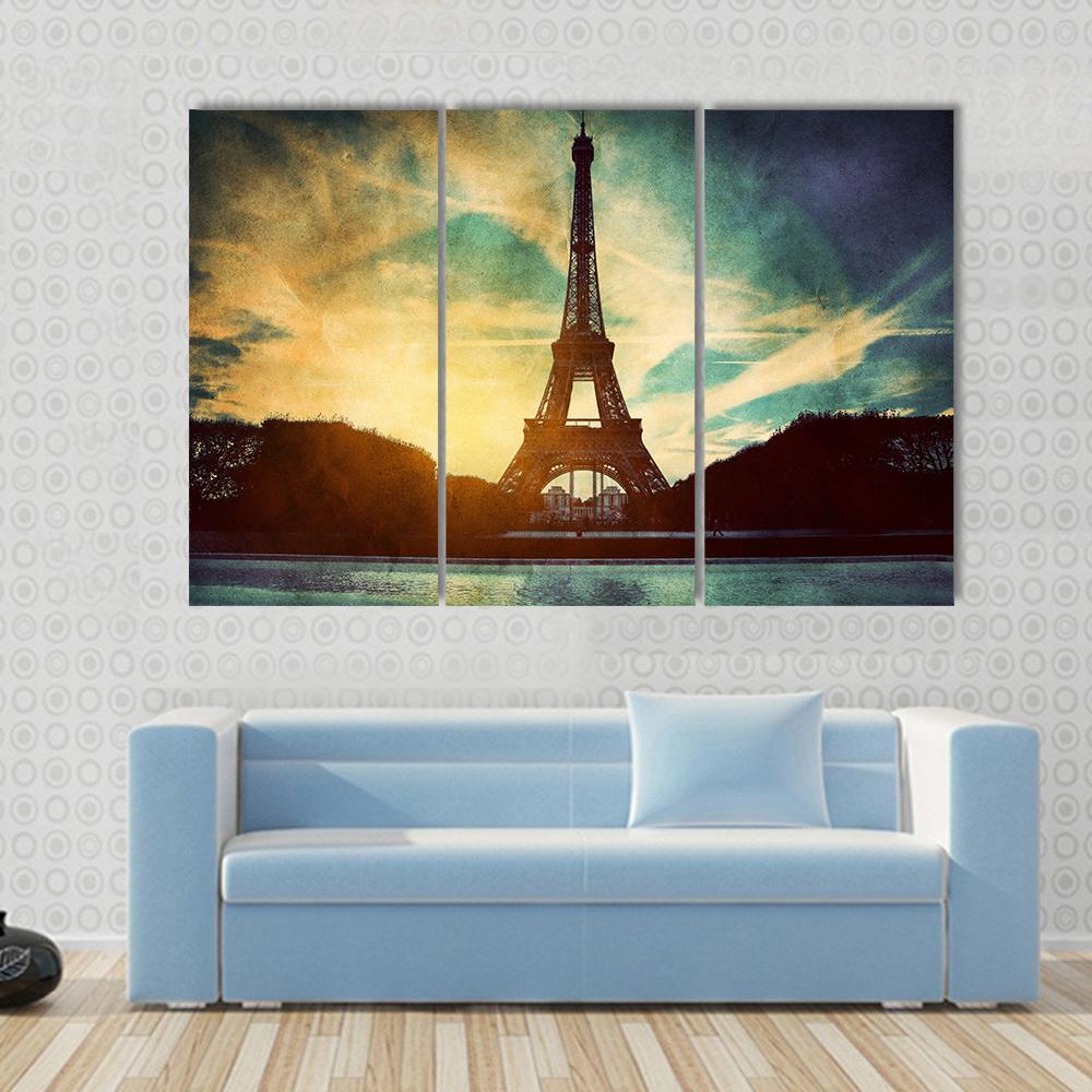 Vintage Retro Eiffel Tower Paris Canvas Wall Art in black, yellow and blue, single panel hung on a wall