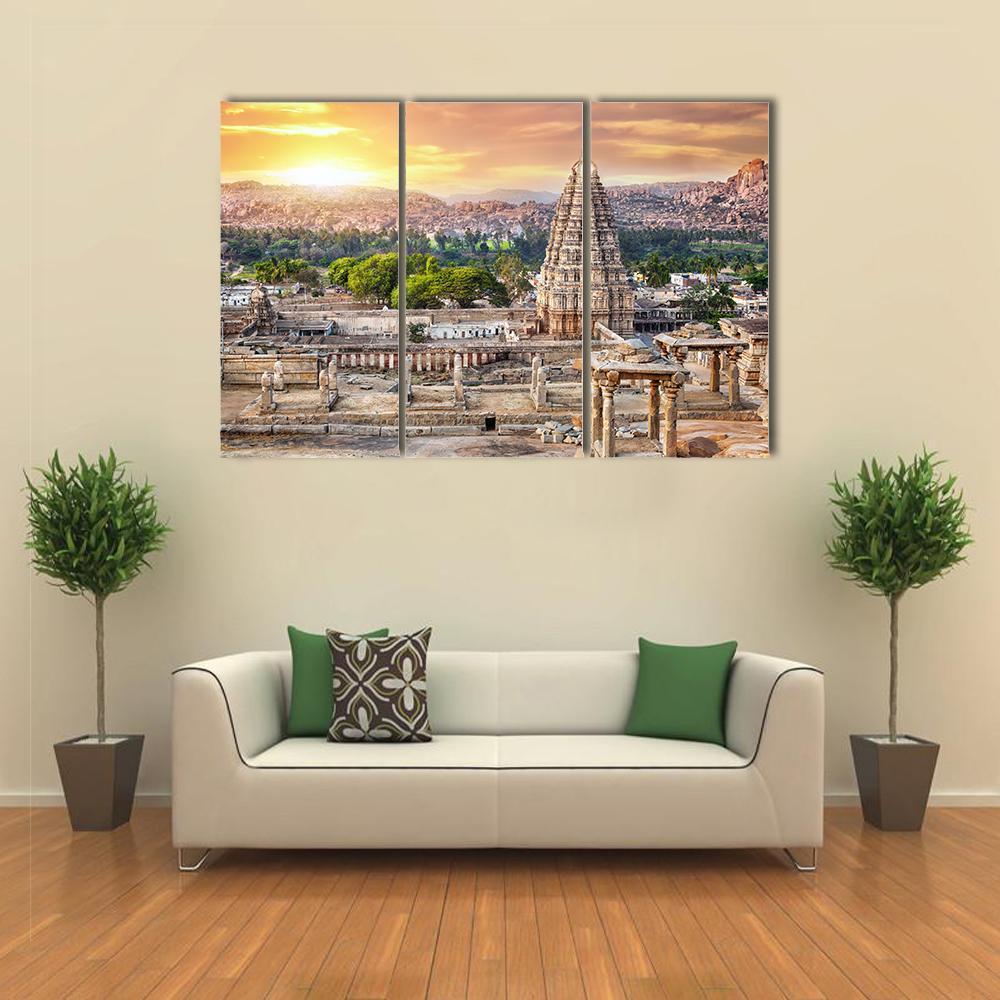 Virupaksha Temple at Sunset in India Canvas Wall Art in brown, orange and yellow, 3 panel horizontal set hung on a wall