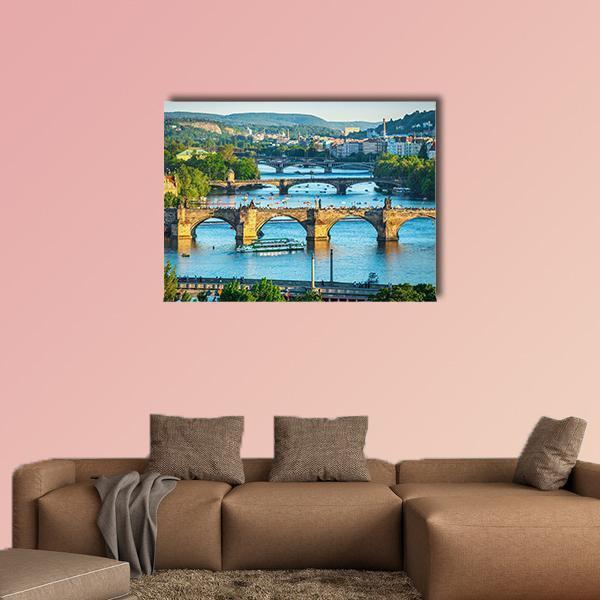 Vltava River and Stone Bridges Canvas Wall Art in brown, green and blue, single panel hung on a wall