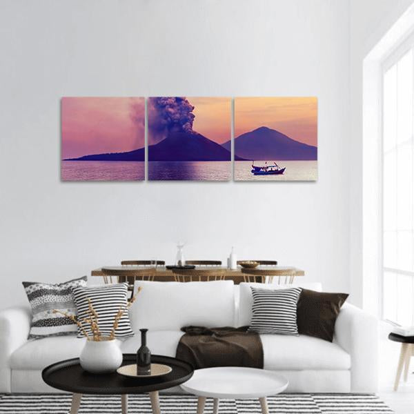Erupting Volcano Over Calm Water Panoramic Canvas Wall Art in orange, yellow and purple, hung on a wall