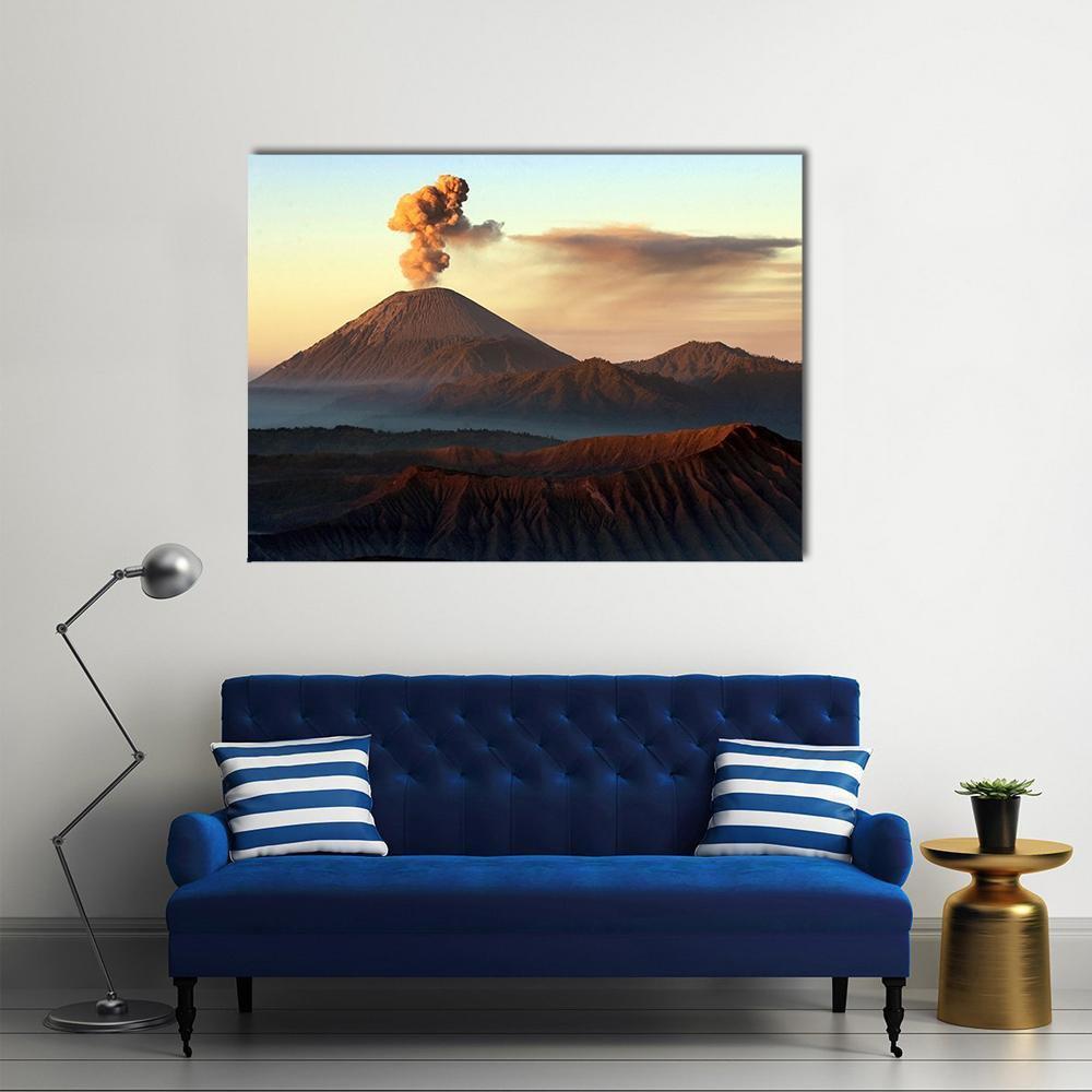 Semeru Volcano Erupting Canvas Wall Art in brown, orange and blue, single panel hung on a wall