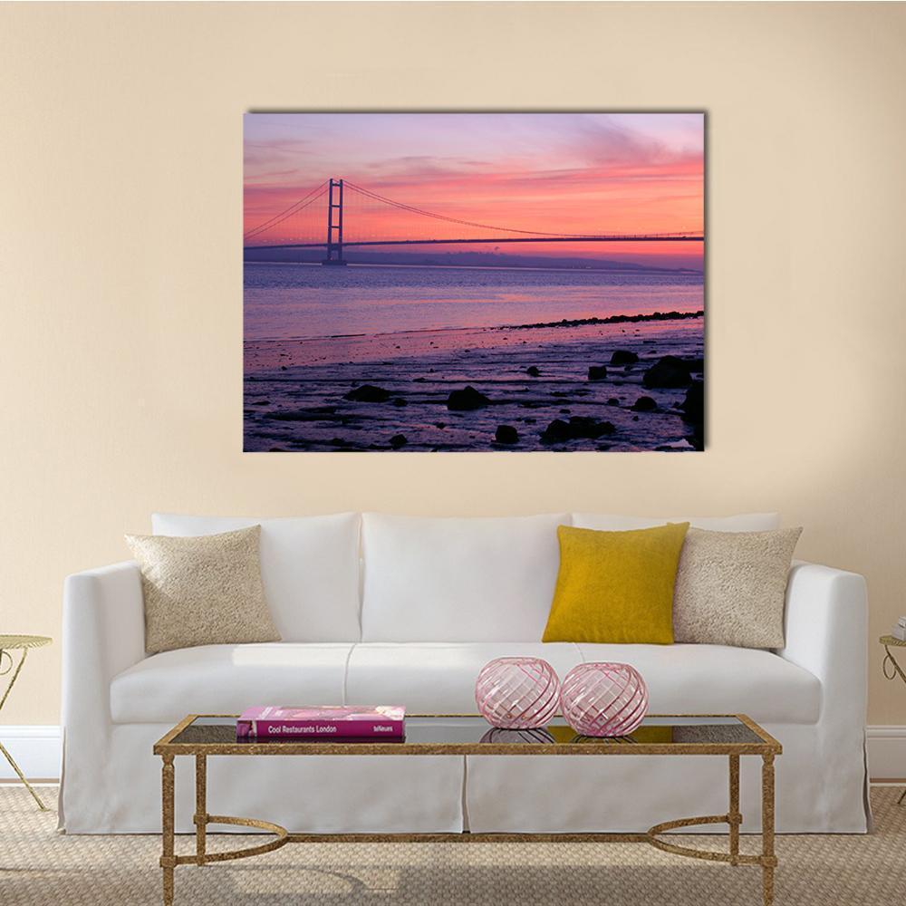 Warm Humber Bridge Sunset Canvas Wall Art in orange, purple and pink, single panel hung on a wall
