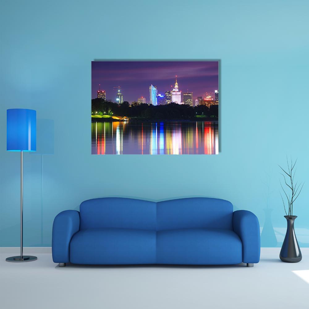 Warsaw Night Skyline Over the River Canvas Wall Art in black, blue and purple, single panel hung on a wall