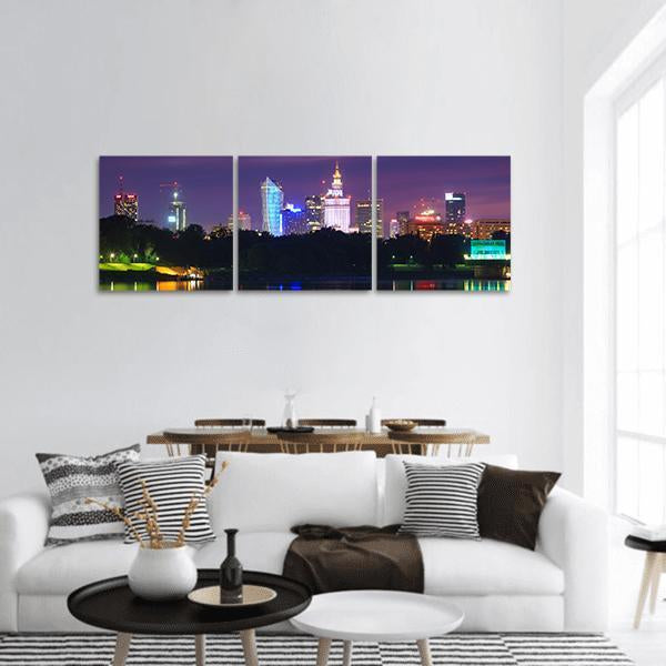Warsaw Night Skyline with Palace of Culture and Science Panoramic Canvas Wall Art in black, blue and purple, hung on a wall