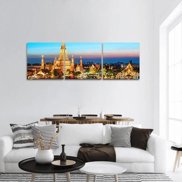 Wat Arun Temple at Dusk, Bangkok Panoramic Canvas Wall Art in gold, orange and blue, hung on a wall