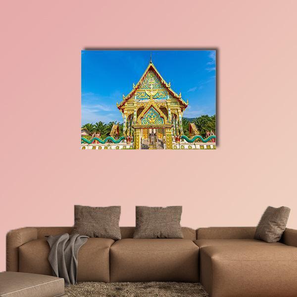 Wat Kaew Manee Si Mahathat Temple Canvas Wall Art in gold, green and blue, single panel hung on a wall