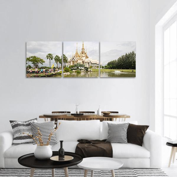 Thai Temple with Gold Spires Panoramic Canvas Wall Art in white, gold and green, hung on a wall