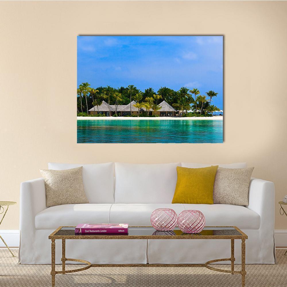 Water Bungalows on a Tropical Island Canvas Wall Art in green and blue, single panel hung on a wall