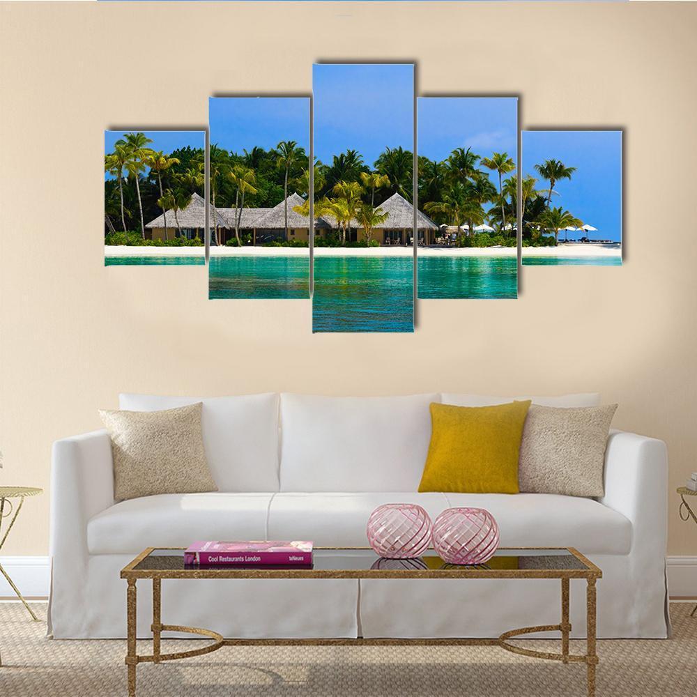 Water Bungalows on a Tropical Island Canvas Wall Art in green and blue, 5 panel Star layout hung on a wall