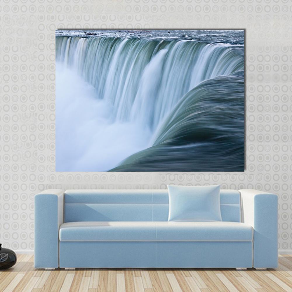 Water Over Niagara Falls Canvas Wall Art in white, green and blue, single panel hung on a wall