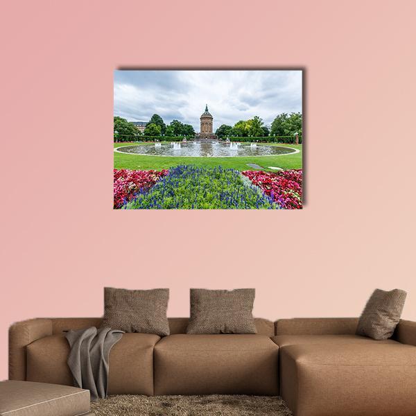 Mannheim Water Tower with Spring Flower Beds Canvas Wall Art in white, green and blue, single panel hung on a wall