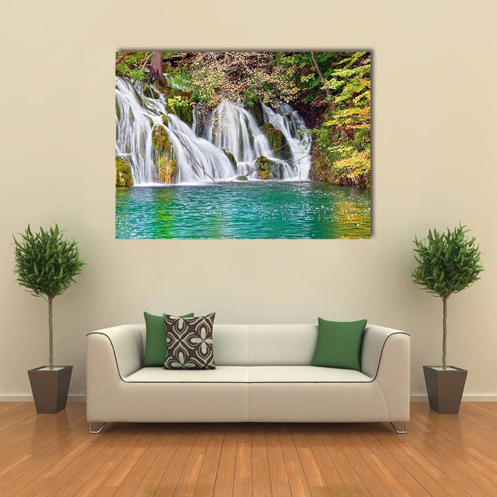 Forest Waterfall and Lake Canvas Wall Art in white, green and blue, single panel hung on a wall