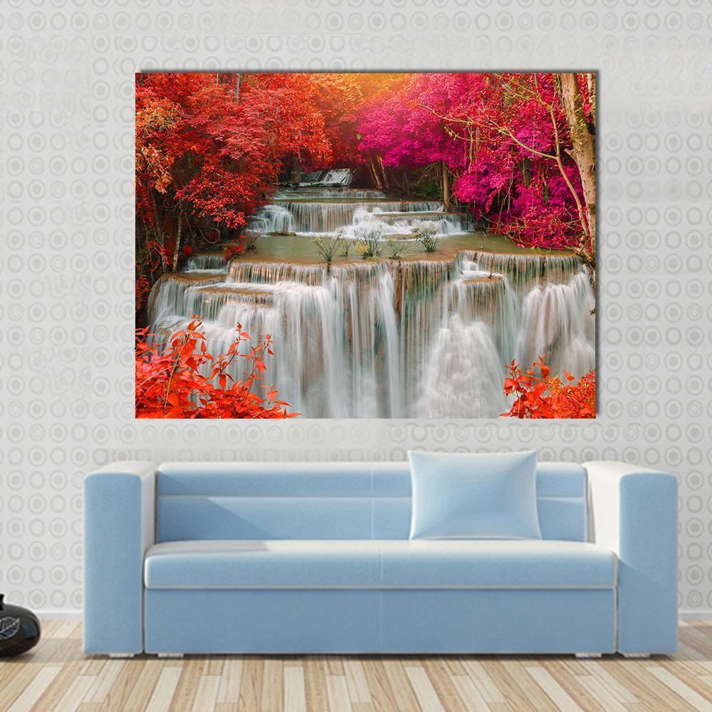 Waterfall in Pink and Red Trees Canvas Wall Art in white, red and pink, single panel hung on a wall