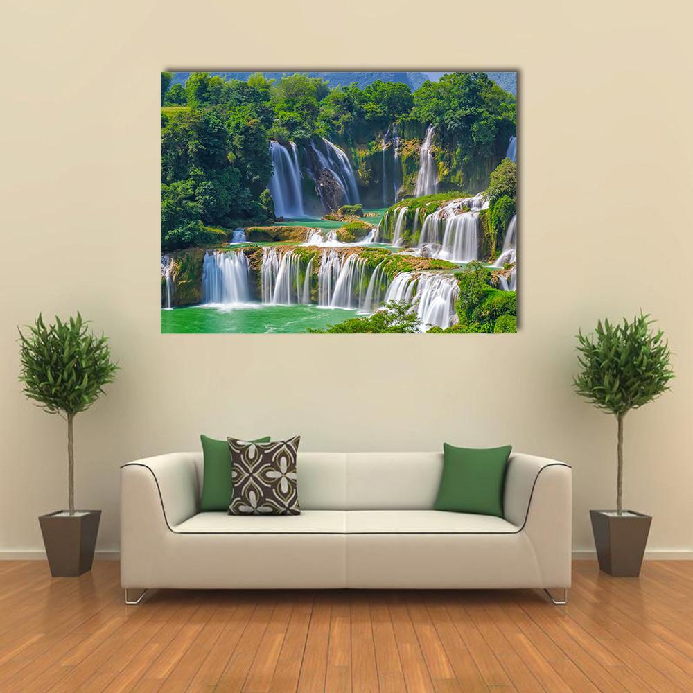 Tiered Tropical Waterfalls with Turquoise Pools Canvas Wall Art in white, green and blue, single panel hung on a wall