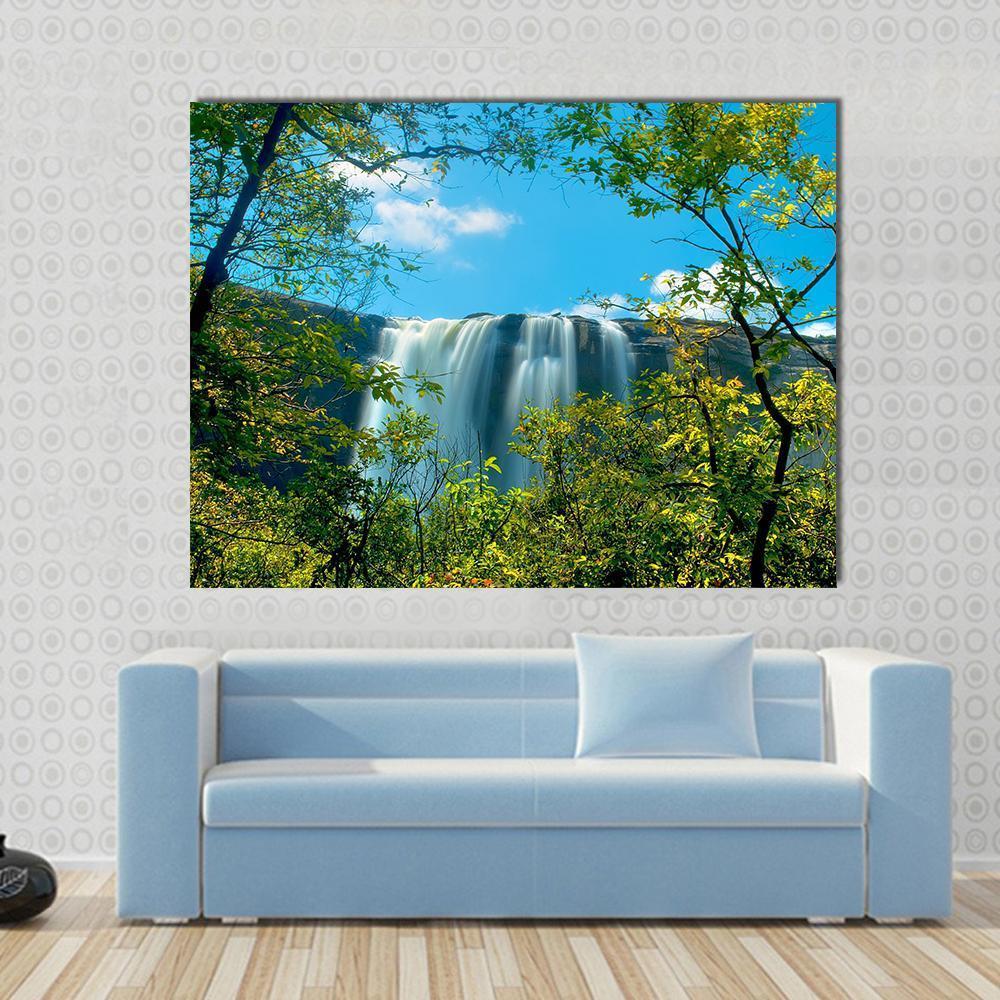 Waterfall in a Forest Athirappally Kerala Canvas Wall Art in white, green and blue, single panel hung on a wall