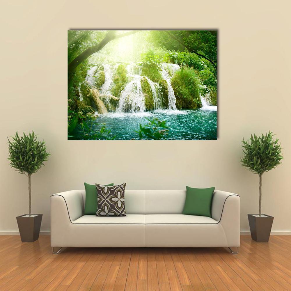 Deep Forest Waterfall with Turquoise Pool Canvas Wall Art in white, green and blue, single panel hung on a wall