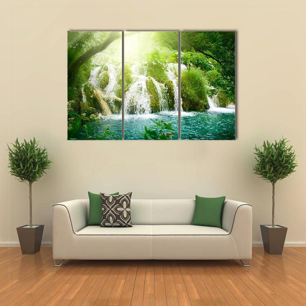 Waterfall in Serene Forest Canvas Wall Art in white, green and blue, 3 panel horizontal set hung on a wall