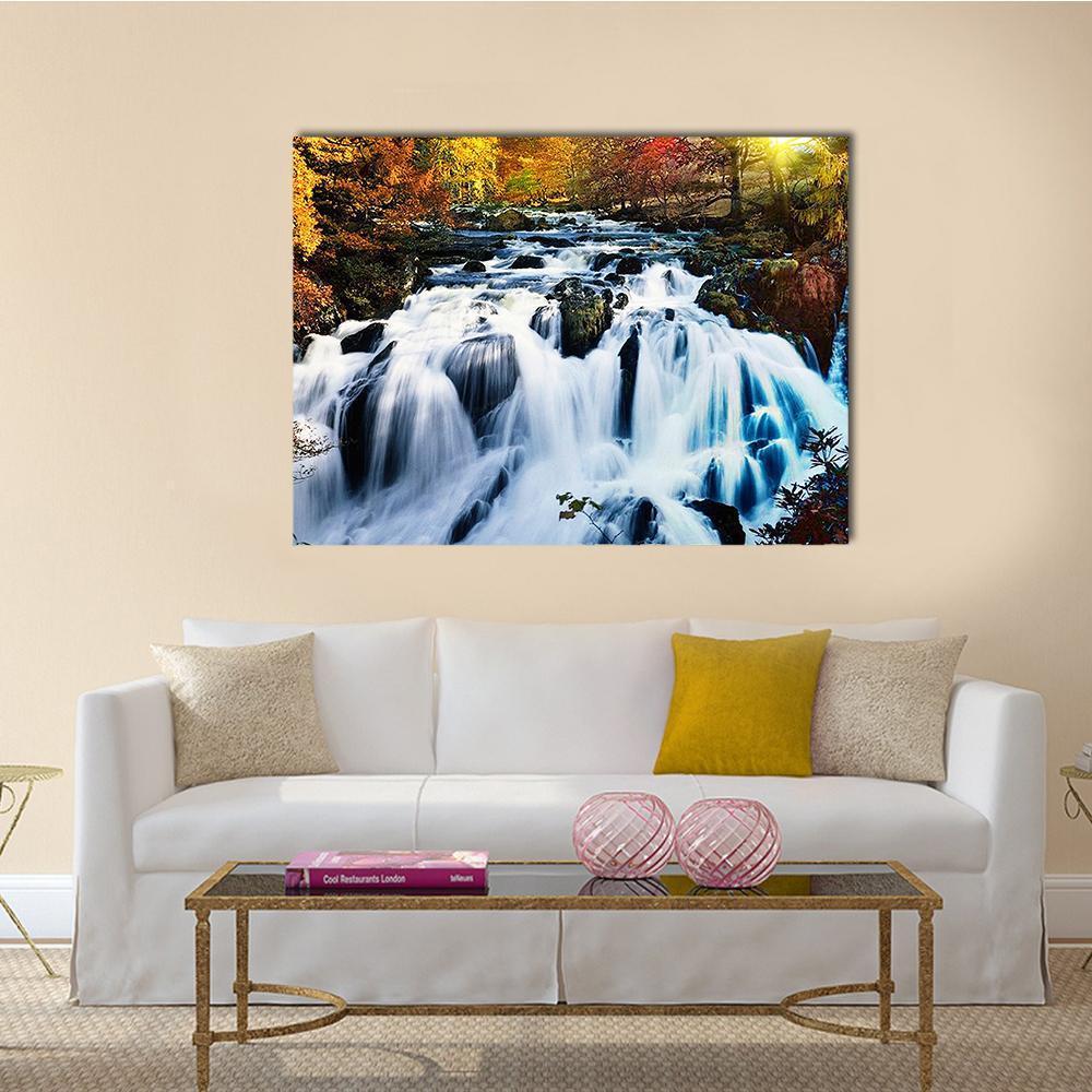 Sunlit Autumn Forest Waterfall Canvas Wall Art in white, orange and yellow, single panel hung on a wall