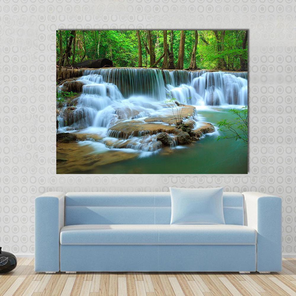 Multi-tiered Waterfall in Green Forest Canvas Wall Art in white, brown and green, single panel hung on a wall