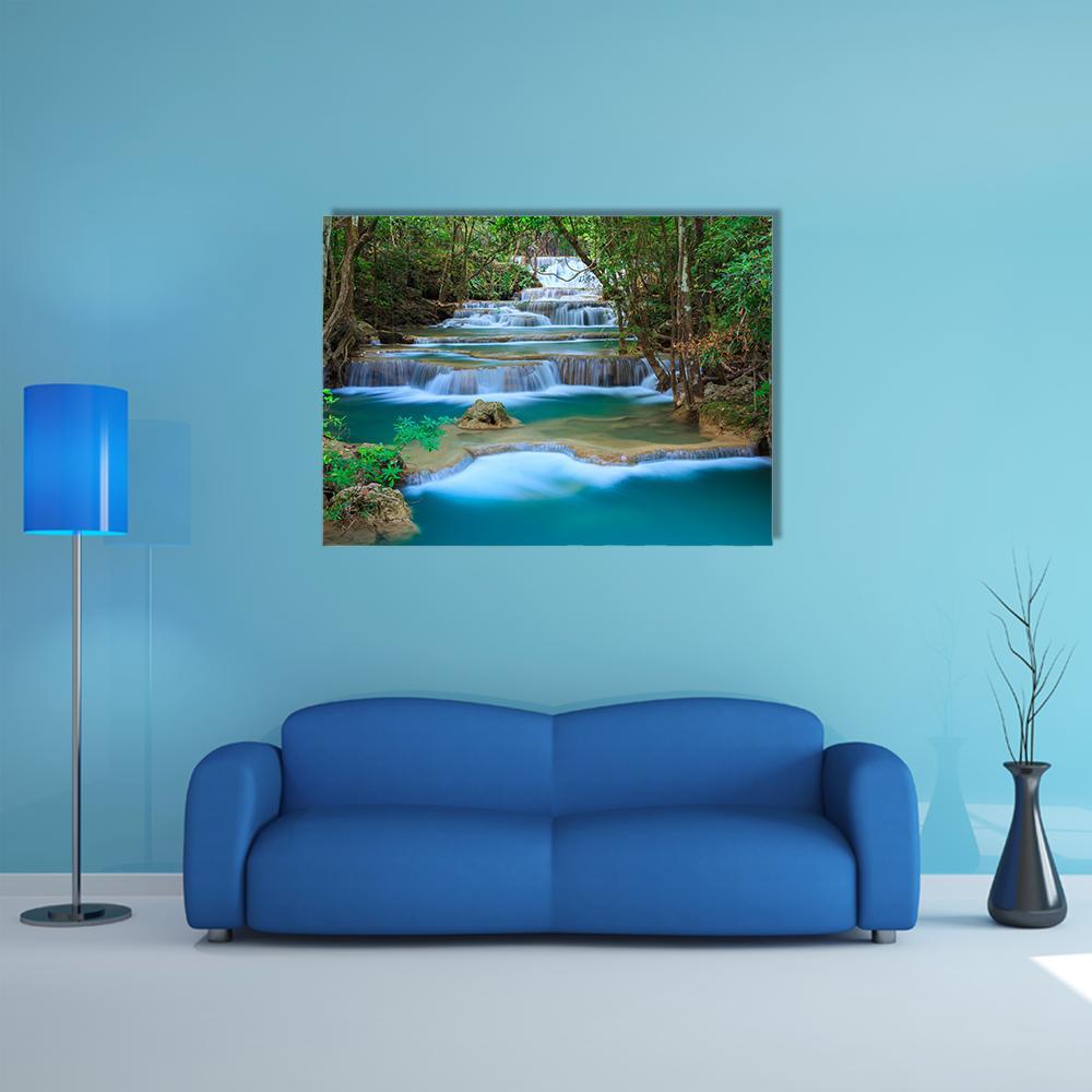 Tiered Tropical Waterfall with Turquoise Pools Canvas Wall Art in white, green and blue, single panel hung on a wall