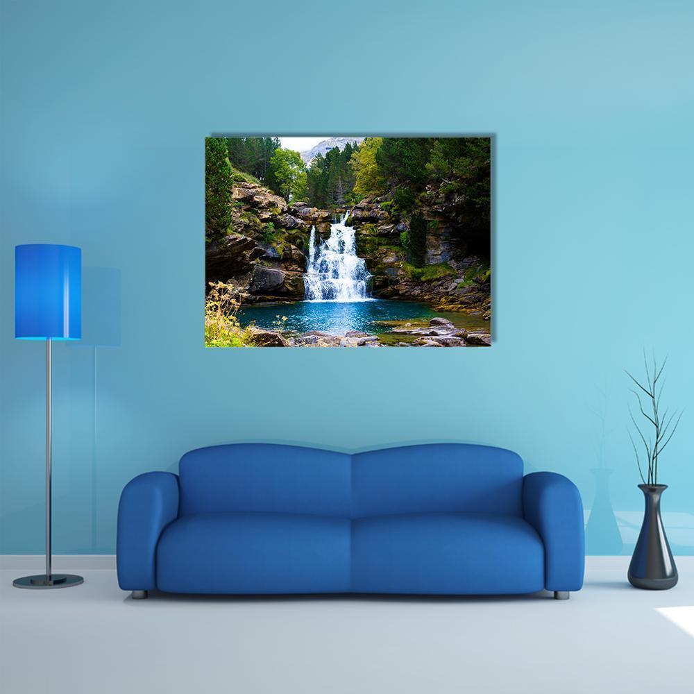 Monter Perdido Waterfall Canvas Wall Art in brown, green and blue, single panel hung on a wall