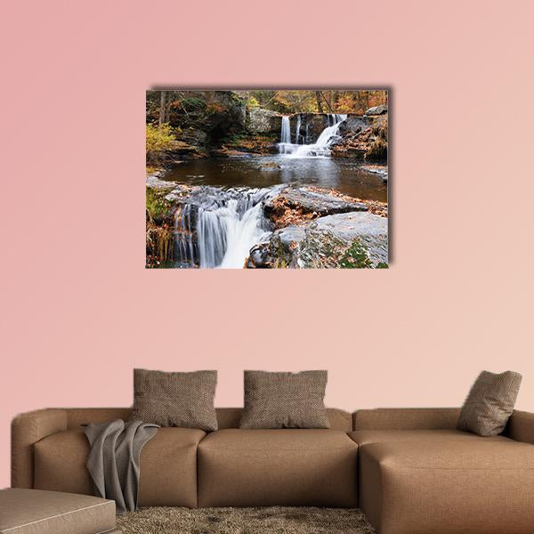 Two-tier Mountain Waterfall with Autumn Leaves Canvas Wall Art in gray, brown and orange, single panel hung on a wall