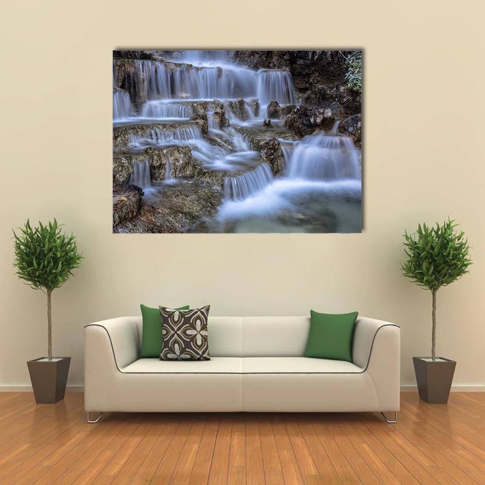 Silky Cascading Waterfall with Rocks Canvas Wall Art in white, gray and blue, single panel hung on a wall