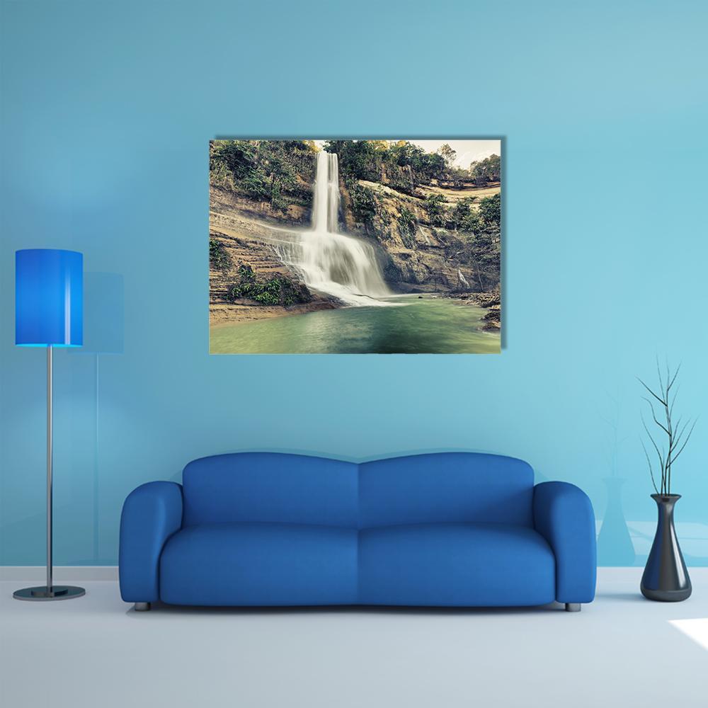 Silky Waterfall Over Layered Cliffs Canvas Wall Art in beige, brown and green, single panel hung on a wall