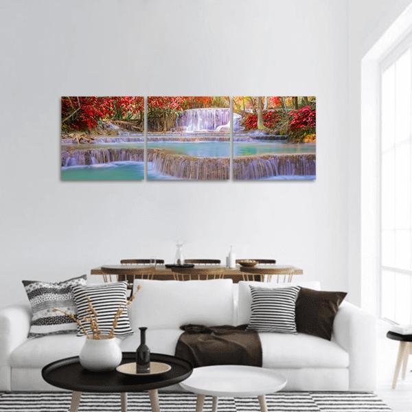 Rainforest Waterfall with Turquoise Pools Panoramic Canvas Wall Art in red, green and blue, hung on a wall