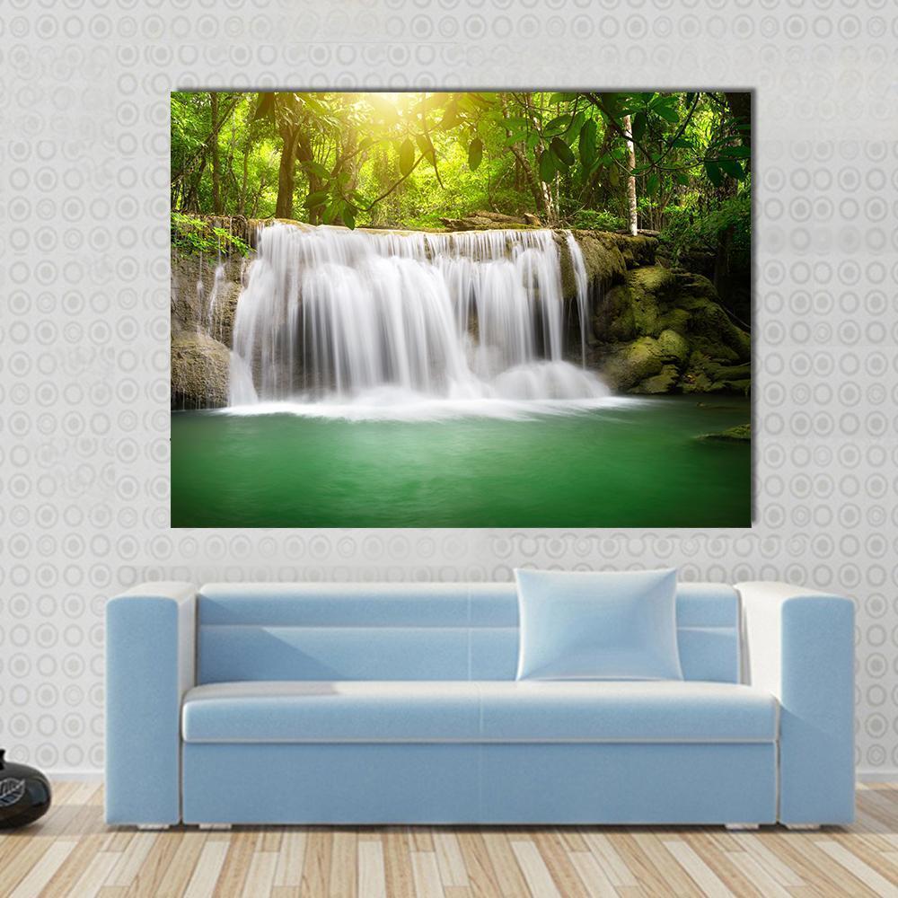 Waterfall in the Green Forest Canvas Wall Art in white, brown and green, single panel hung on a wall