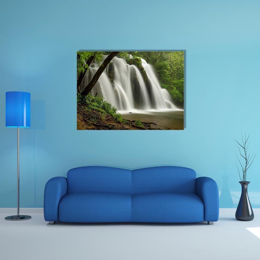 Jura Mountains Waterfall Canvas Wall Art in white, brown and green, single panel hung on a wall