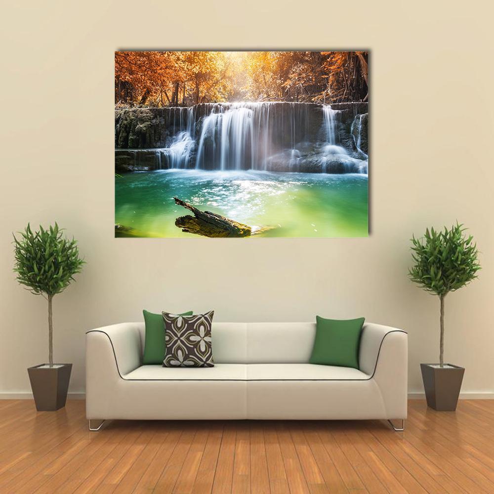 Tropical Rainforest Waterfall Canvas Wall Art in orange, green and blue, single panel hung on a wall