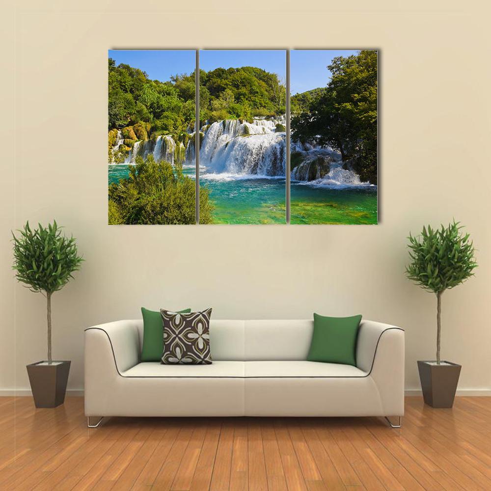 Krka Waterfall in Croatia Canvas Wall Art in white, green and blue, 3 panel horizontal set hung on a wall