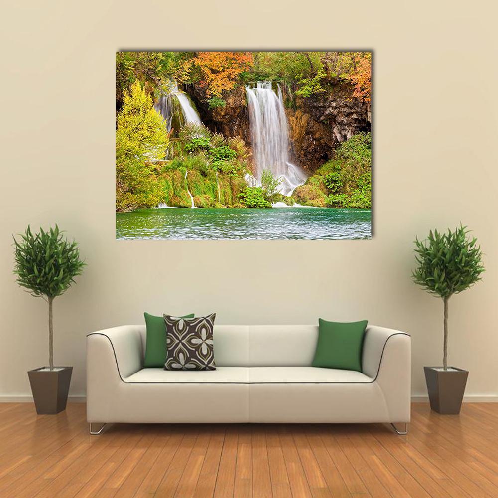 Autumn Waterfall at Plitvice Lakes Canvas Wall Art in brown, orange and green, single panel hung on a wall