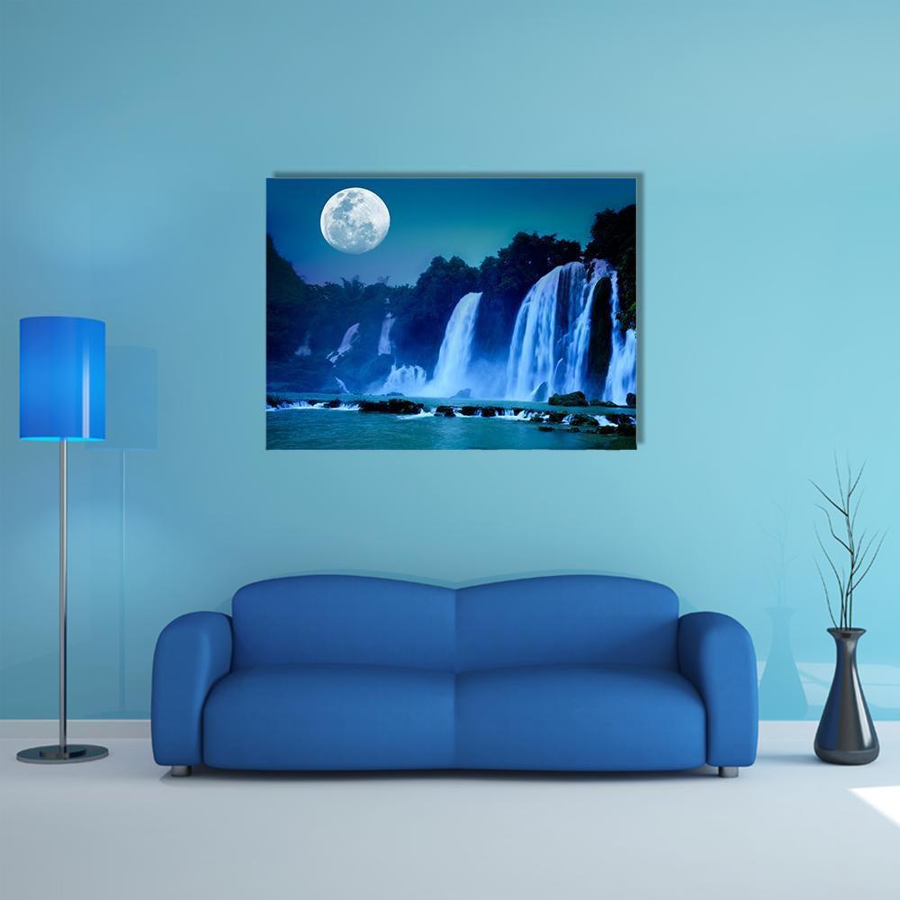 Moonlit Waterfall Canvas Wall Art in white, blue and navy, single panel hung on a wall