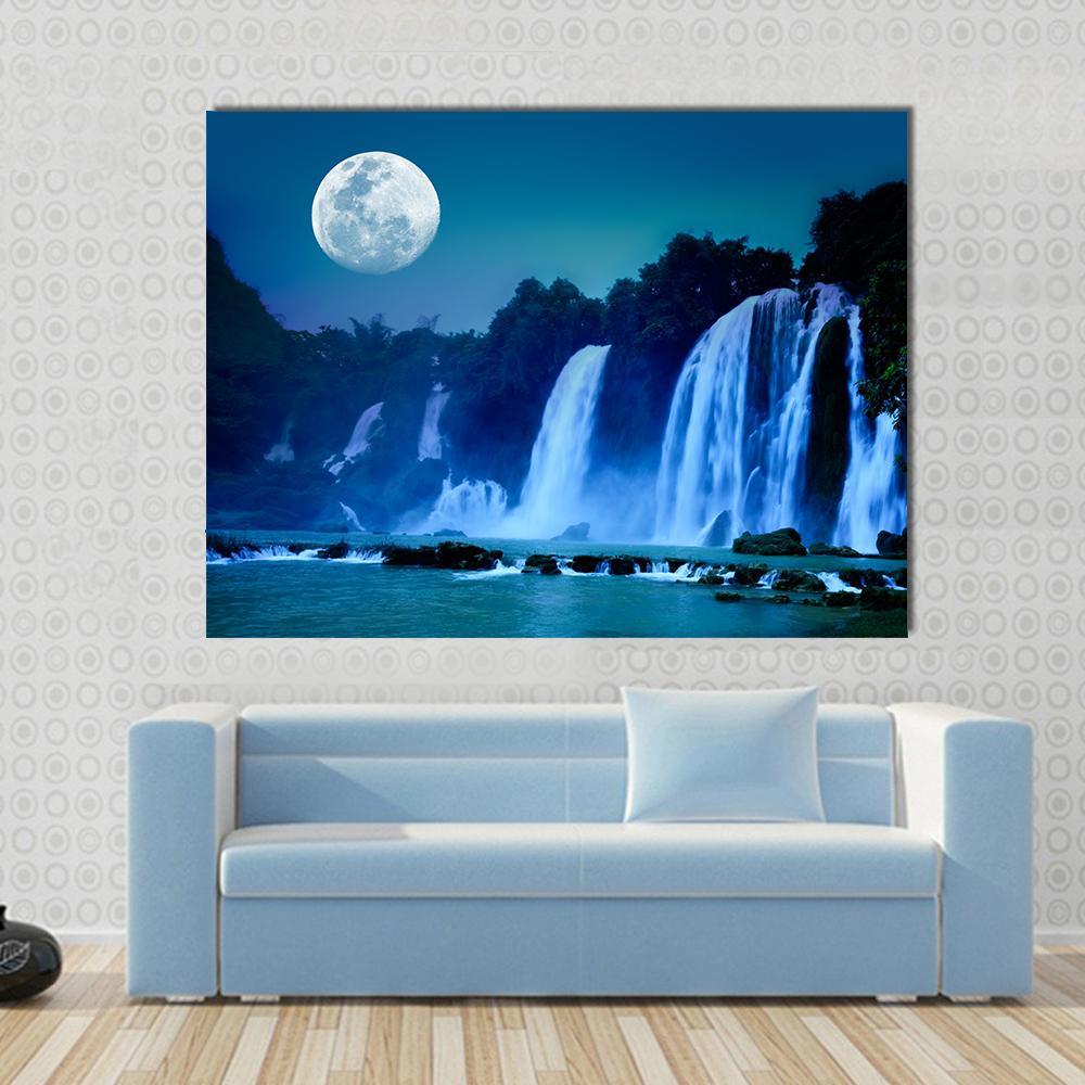 Full Moon Over Tiered Waterfall Canvas Wall Art in white, blue and navy, single panel hung on a wall