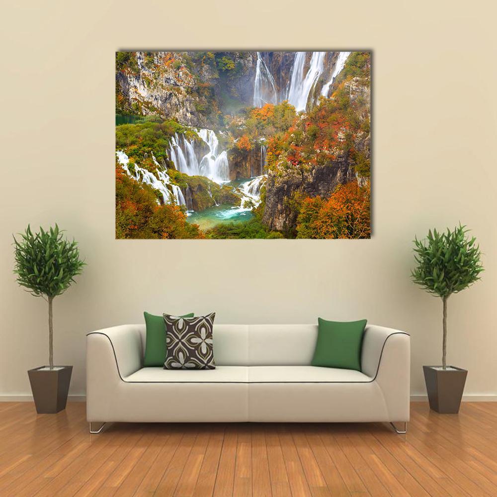 Cascading Waterfalls in Autumn Colors Canvas Wall Art in brown, orange and green, single panel hung on a wall