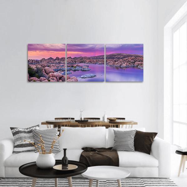 Watson Lake Sunset Panoramic Canvas Wall Art in orange, purple and pink, hung on a wall